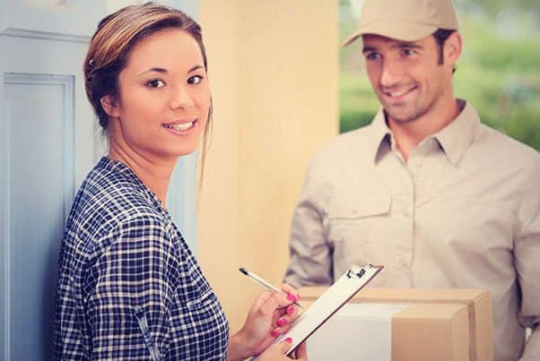 A delivery man delivering roller shutter order to a woman